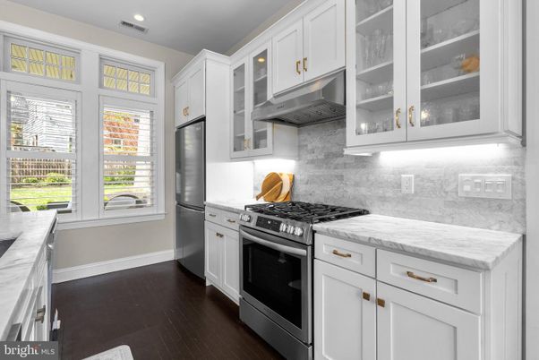 Interior, Kitchen, Marble Walls, Recessed Lighting, Stainless Steel Appliances, Wood Texture Flooring