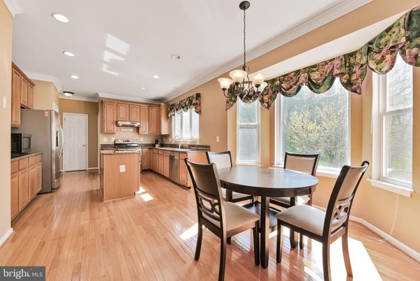 Chandelier, Dining room, Interior, Kitchen, Pendant Lights, Recessed Lighting, Stainless Steel Appliances, Wood Texture Flooring