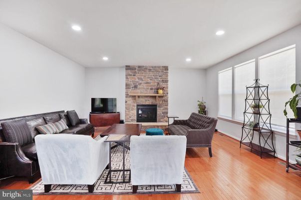 Fireplace, Interior, Living room, Recessed Lighting, Stone Walls, Wood Texture Flooring