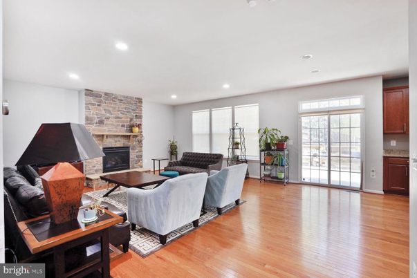 Fireplace, Interior, Living room, Piano, Recessed Lighting, Stone Walls, Wood Texture Flooring