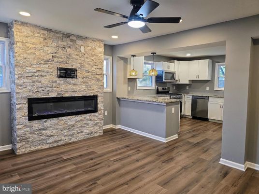 Fireplace, Interior, Kitchen, Pendant Lights, Recessed Lighting, Stainless Steel Appliances, Stone Walls, Wood Texture Flooring