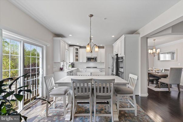 Chandelier, Dining room, Interior, Kitchen, Pendant Lights, Recessed Lighting, Stainless Steel Appliances, Wood Texture Flooring