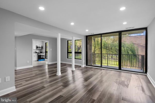Empty room, Interior, Kitchen, Recessed Lighting, Stainless Steel Appliances, Wood Texture Flooring