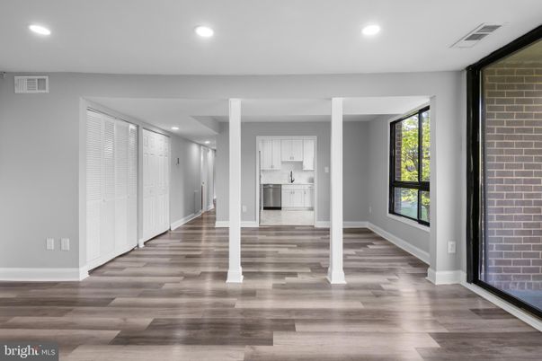 Empty room, Interior, Kitchen, Recessed Lighting, Stainless Steel Appliances, Stone Walls, Wood Texture Flooring