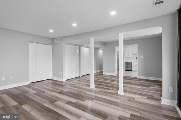 Empty room, Interior, Kitchen, Recessed Lighting, Stainless Steel Appliances, Wood Texture Flooring