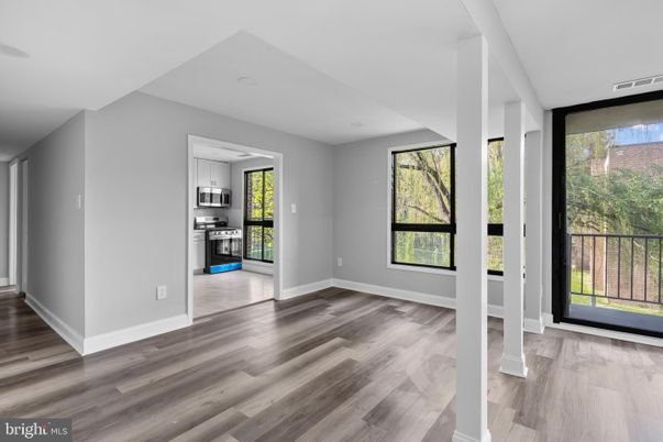 Empty room, Interior, Kitchen, Recessed Lighting, Stainless Steel Appliances, Wood Texture Flooring