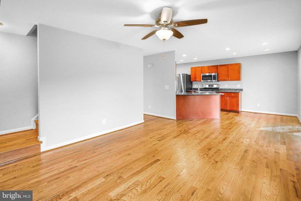 Empty room, Interior, Kitchen, Recessed Lighting, Stainless Steel Appliances, Wood Texture Flooring