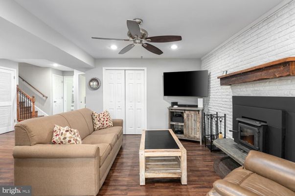 Fireplace, Interior, Living room, Recessed Lighting, Stone Walls, Wood Texture Flooring