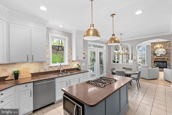 Chandelier, Dining room, Fireplace, Interior, Kitchen, Living room, Pendant Lights, Recessed Lighting, Stainless Steel Appliances