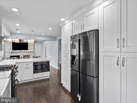 Fireplace, Interior, Kitchen, Pendant Lights, Recessed Lighting, Stainless Steel Appliances, Stone Walls, Wood Texture Flooring
