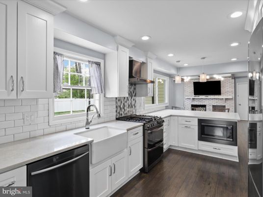 Fireplace, Interior, Kitchen, Pendant Lights, Recessed Lighting, Stainless Steel Appliances, Stone Walls, Wood Texture Flooring