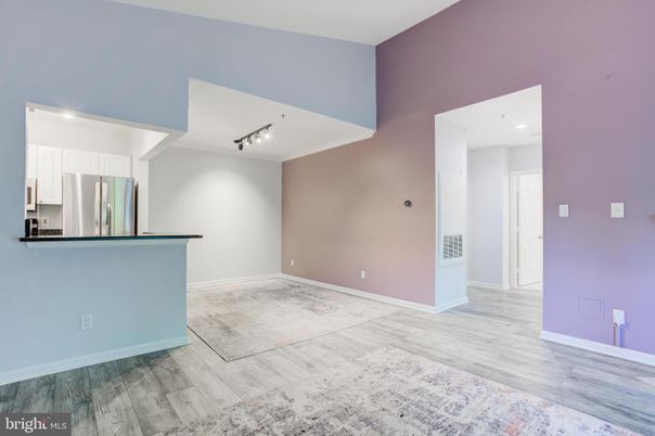 Empty room, Interior, Kitchen, Recessed Lighting, Stainless Steel Appliances, Wood Texture Flooring