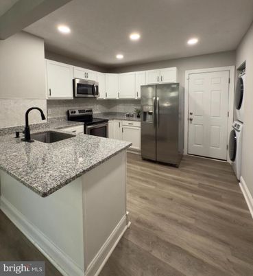 Interior, Kitchen, Recessed Lighting, Stainless Steel Appliances, Washer, Wood Texture Flooring