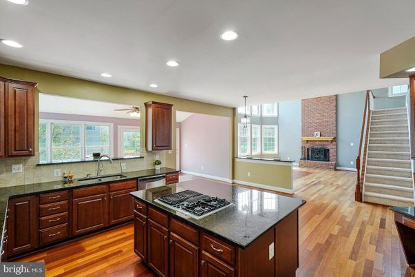 Fireplace, Interior, Kitchen, Pendant Lights, Recessed Lighting, Stone Walls, Wood Texture Flooring