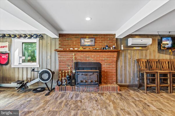 Fireplace, Fitness Equipment, Interior, Recessed Lighting, Stone Walls, Wood Texture Flooring, Wooden Walls