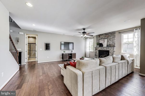 Fireplace, Interior, Living room, Recessed Lighting, Stone Walls, Wood Texture Flooring