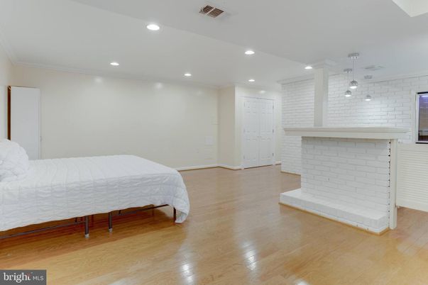 Bedroom, Fireplace, Interior, Pendant Lights, Recessed Lighting, Wood Texture Flooring