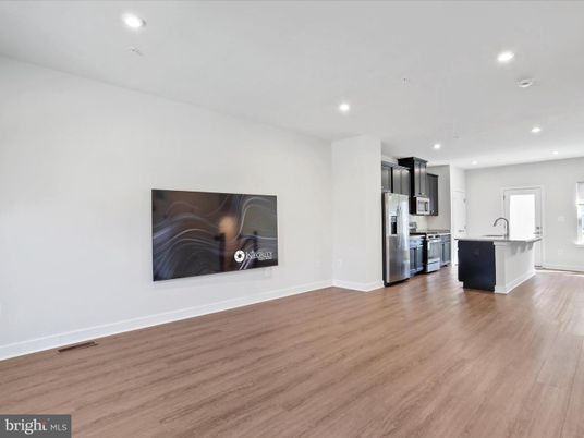 Empty room, Interior, Kitchen, Recessed Lighting, Stainless Steel Appliances, Wood Texture Flooring