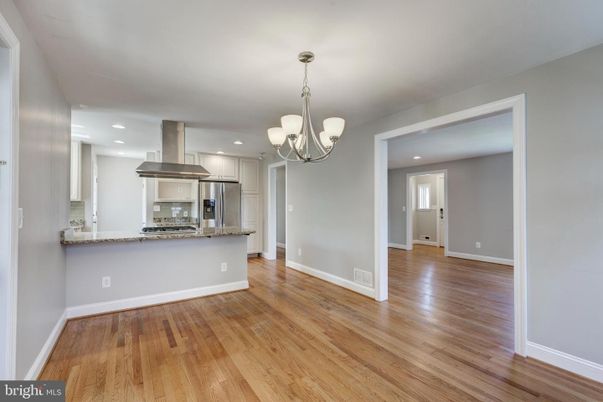Chandelier, Empty room, Interior, Kitchen, Recessed Lighting, Stainless Steel Appliances, Wood Texture Flooring