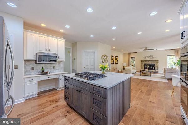 Dining room, Fireplace, Interior, Kitchen, Living room, Recessed Lighting, Stainless Steel Appliances, Wood Texture Flooring