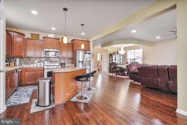 Chandelier, Dining room, Interior, Kitchen, Living room, Pendant Lights, Recessed Lighting, Stainless Steel Appliances, Wood Texture Flooring