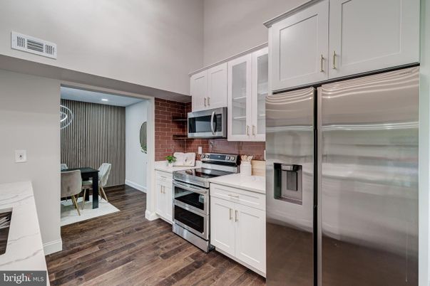 Dining room, Interior, Kitchen, Recessed Lighting, Stainless Steel Appliances, Stone Walls, Wood Texture Flooring