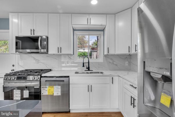 Interior, Kitchen, Marble Walls, Recessed Lighting, Stainless Steel Appliances, Wood Texture Flooring