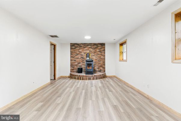 Empty room, Fireplace, Interior, Recessed Lighting, Stone Walls, Wood Texture Flooring