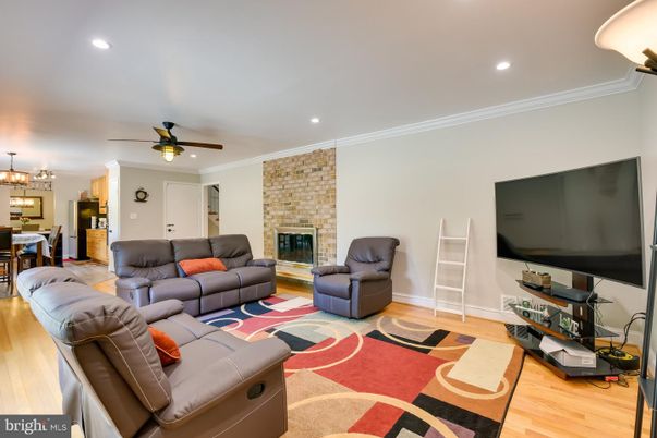 Chandelier, Dining room, Fireplace, Interior, Living room, Recessed Lighting, Stone Walls, Wood Texture Flooring