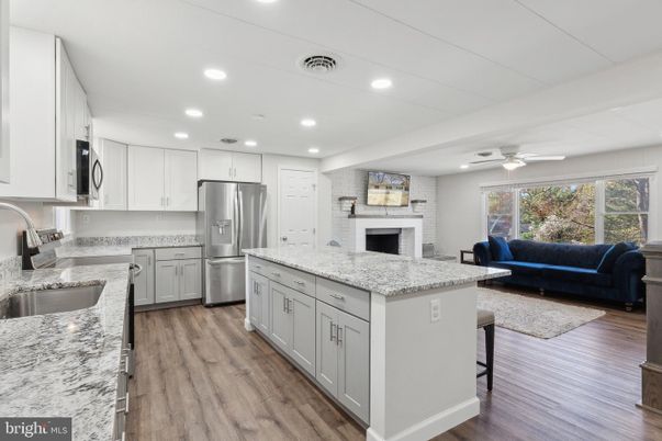 Fireplace, Interior, Kitchen, Living room, Recessed Lighting, Stainless Steel Appliances, Stone Walls, Wood Texture Flooring