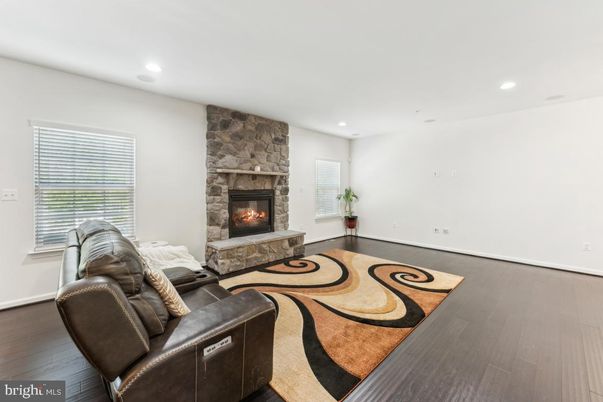 Fireplace, Interior, Living room, Recessed Lighting, Stone Walls, Wood Texture Flooring