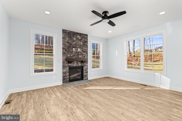 Empty room, Fireplace, Interior, Recessed Lighting, Stone Walls, Wood Texture Flooring