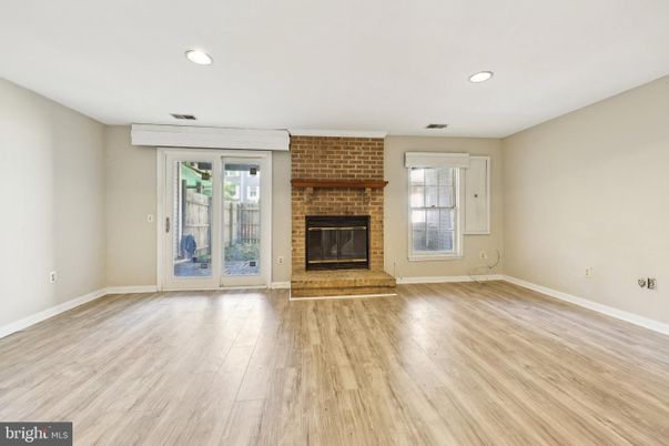 Empty room, Fireplace, Interior, Recessed Lighting, Stone Walls, Wood Texture Flooring