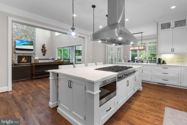 Fireplace, Interior, Kitchen, Living room, Pendant Lights, Recessed Lighting, Stainless Steel Appliances, Stone Walls, Wood Texture Flooring