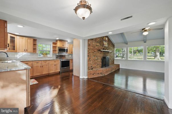 Fireplace, Interior, Kitchen, Recessed Lighting, Stainless Steel Appliances, Stone Walls, Wood Texture Flooring
