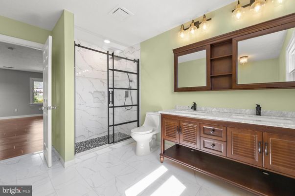 Bathroom, Dual Sink Vanities, Glass Shower, Interior, Marble, Marble Walls, Recessed Lighting, Wood Texture Flooring