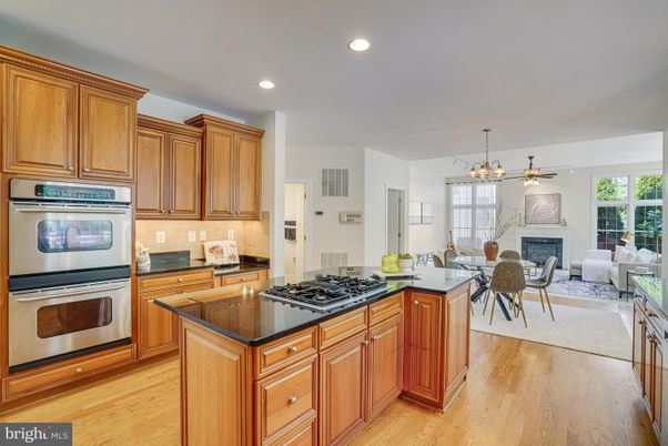Dining room, Fireplace, Interior, Kitchen, Living room, Pendant Lights, Recessed Lighting, Stainless Steel Appliances, Wood Texture Flooring