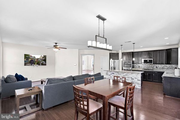 Chandelier, Dining room, Interior, Kitchen, Living room, Pendant Lights, Recessed Lighting, Stainless Steel Appliances, Wood Texture Flooring
