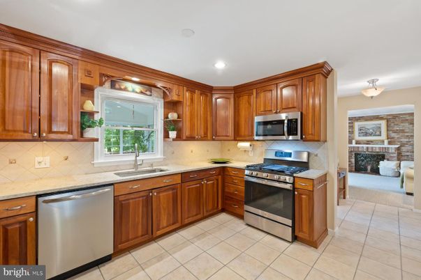 Fireplace, Interior, Kitchen, Recessed Lighting, Stainless Steel Appliances, Stone Walls