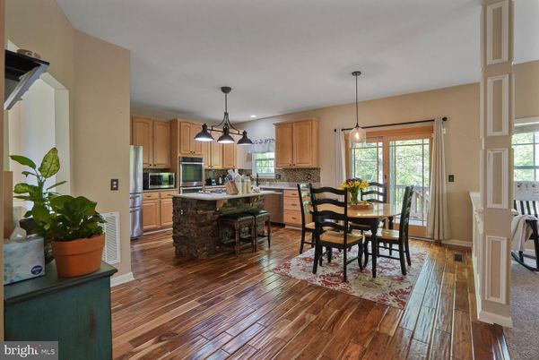 Dining room, Interior, Kitchen, Pendant Lights, Recessed Lighting, Stainless Steel Appliances, Wood Texture Flooring