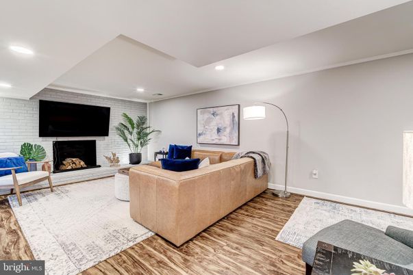 Fireplace, Interior, Living room, Recessed Lighting, Stone Walls, Wood Texture Flooring