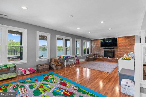 Fireplace, Interior, Living room, Recessed Lighting, Stone Walls, Wood Texture Flooring
