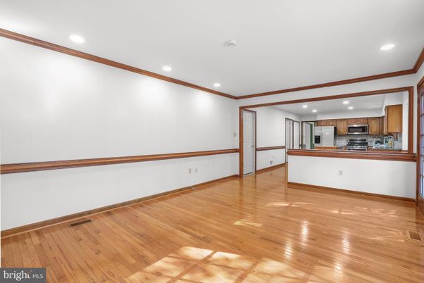 Empty room, Interior, Kitchen, Recessed Lighting, Stainless Steel Appliances, Wood Texture Flooring