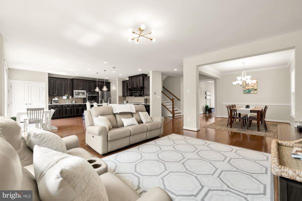 Chandelier, Dining room, Interior, Kitchen, Living room, Pendant Lights, Recessed Lighting, Stainless Steel Appliances, Wood Texture Flooring