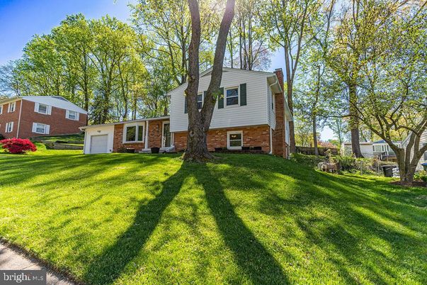 Attached, Backyard, Exterior, Facade, Brick Facade, Raised Ranch