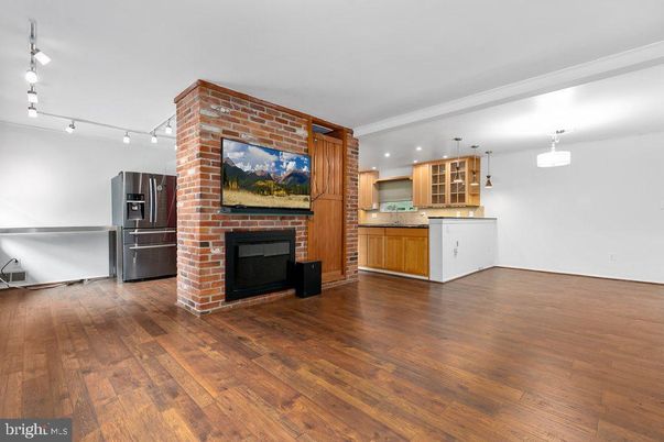Fireplace, Interior, Kitchen, Pendant Lights, Stainless Steel Appliances, Stone Walls, Wood Texture Flooring
