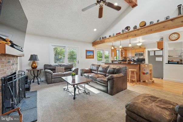 Fireplace, Interior, Kitchen, Living room, Pendant Lights, Recessed Lighting, Stainless Steel Appliances, Stone Walls, Wooden Beams, Wood Texture Flooring