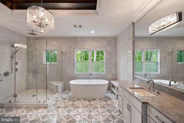 Bathroom, Chandelier, Dual Sink Vanities, Free Standing Baths, Glass Shower, Interior, Marble Walls, Recessed Lighting