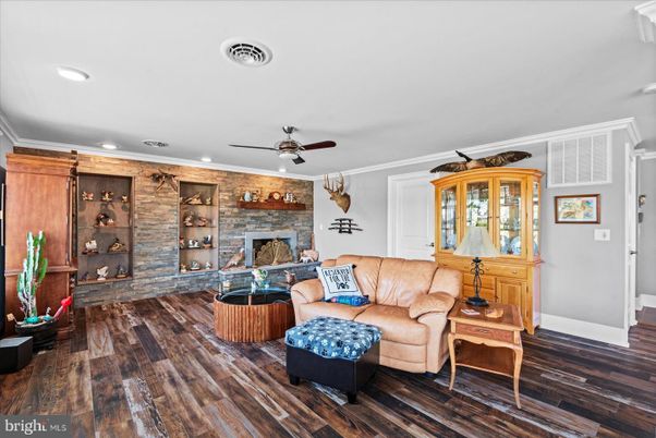 Fireplace, Interior, Living room, Recessed Lighting, Stone Walls, Wood Texture Flooring