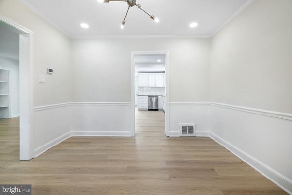 Empty room, Interior, Kitchen, Recessed Lighting, Stainless Steel Appliances, Wood Texture Flooring